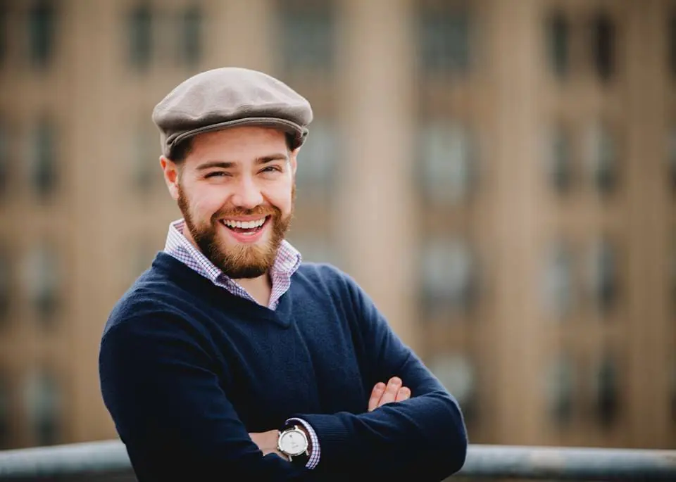 Headshot of Steven Blondo crossing his arms and smiling