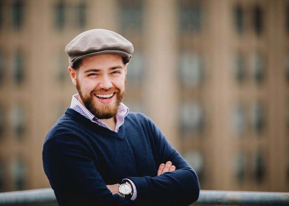 Headshot of Steven Blondo crossing his arms and smiling